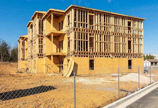 a close-up of temporary chain link fences enclosing a job site, signaling progress in the project's development in Dulac